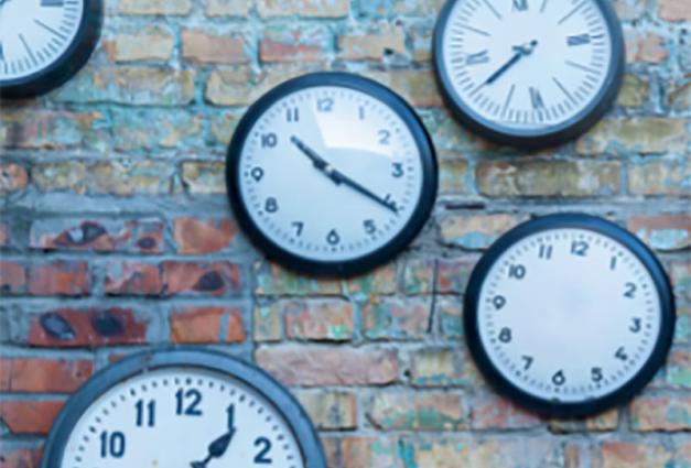 Clocks on a brick wall