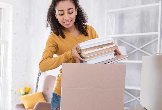 Woman packing books into box