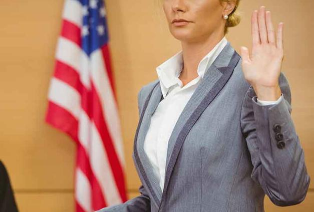 Woman taking oath in courtroom