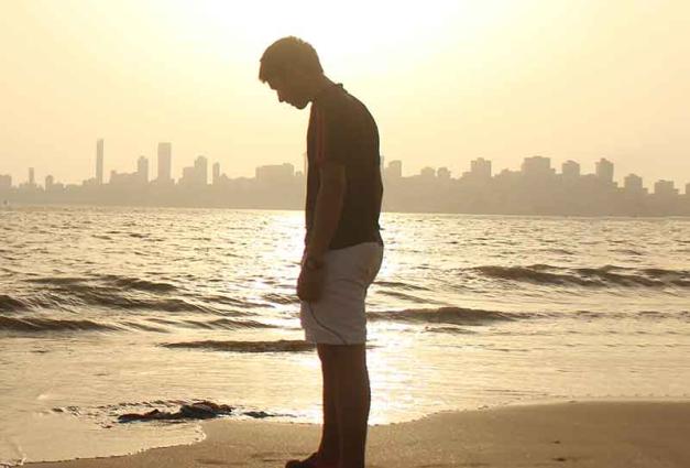 Young man alone on beach