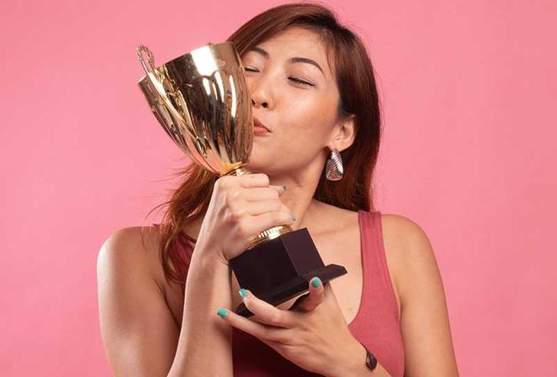 Woman kissing a trophy