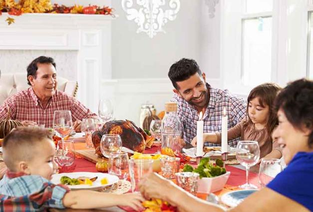Photo of Family With Grandparents Enjoying Thanksgiving Meal At Table
