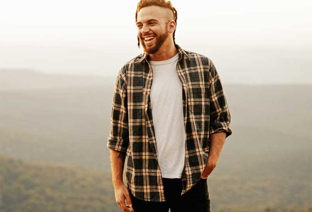 Smiling man standing on mountain