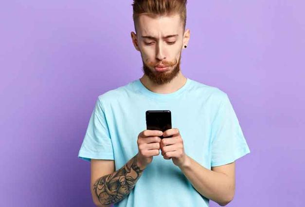 Young man looking at smartphone