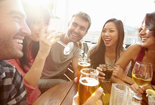 Image of younger men and women enjoying drinks together