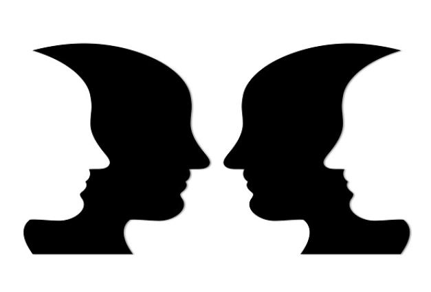 Illustration of two black face silhouettes overlapped by two white face silhouettes