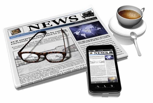 Image of newspaper, reading glasses, smartphone and cup of coffee