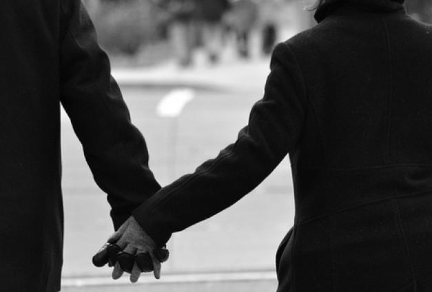 An image of a couple holding hands