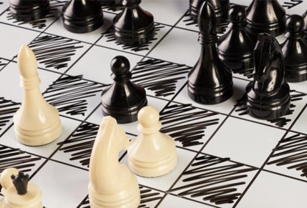 Image of black and white chess pieces on a chessboard