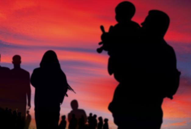 Image of silhouetted group of people walking against a colorful sunset backdrop