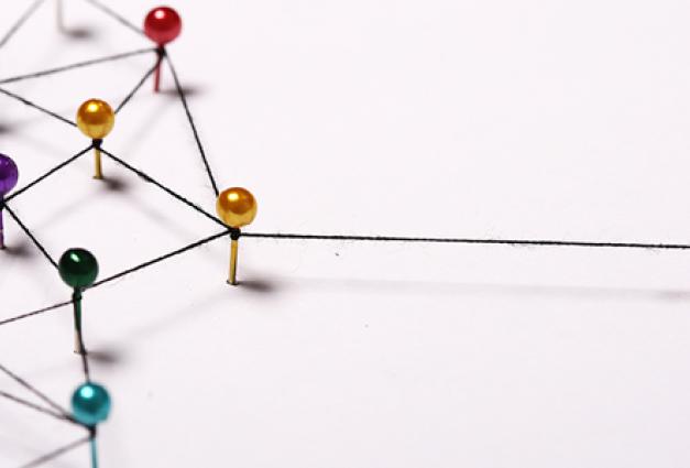 image of pushpins connected by string