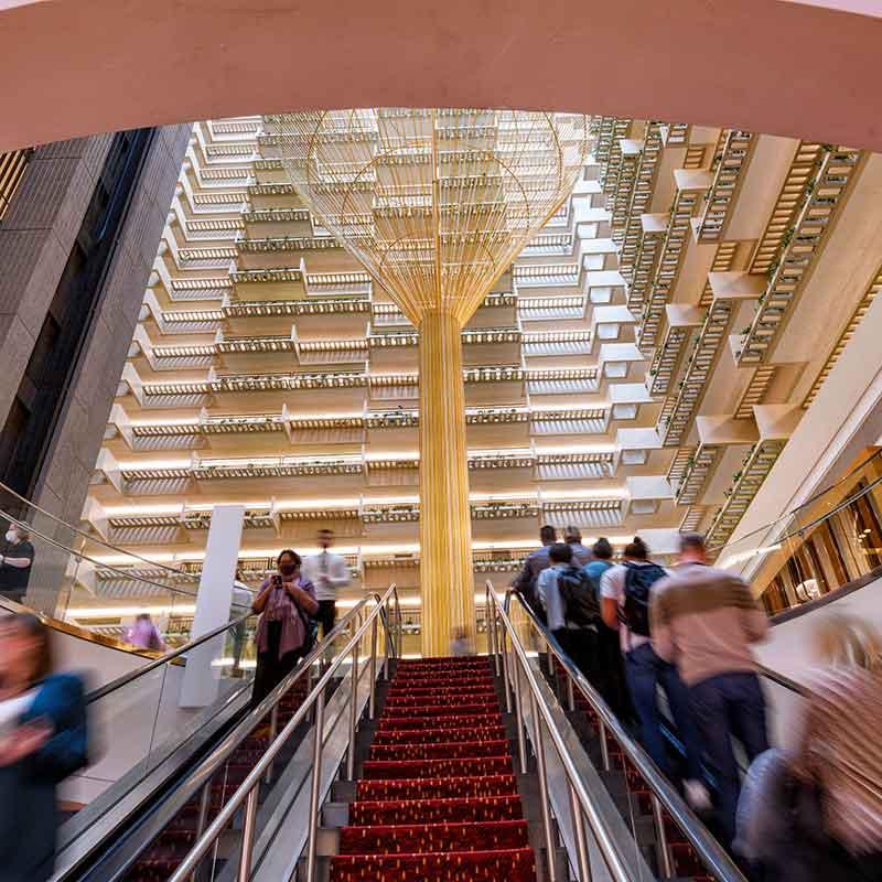 People on an escalator in a hotel lobby