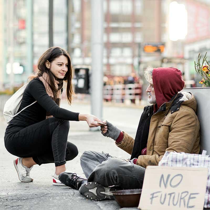 Homeless and woman exchanging money