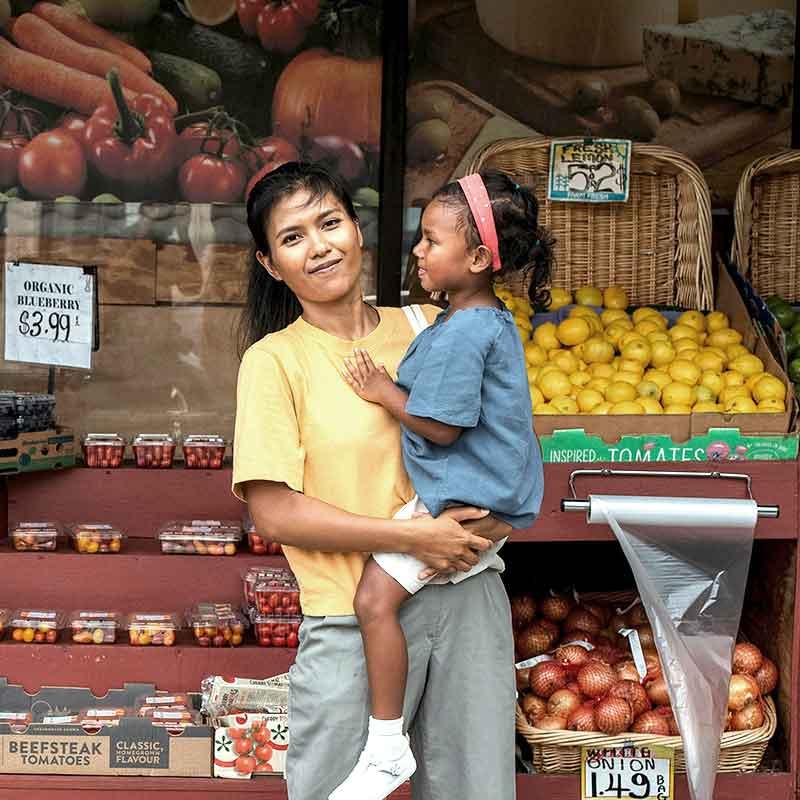 Mother and daughter in outdoor market