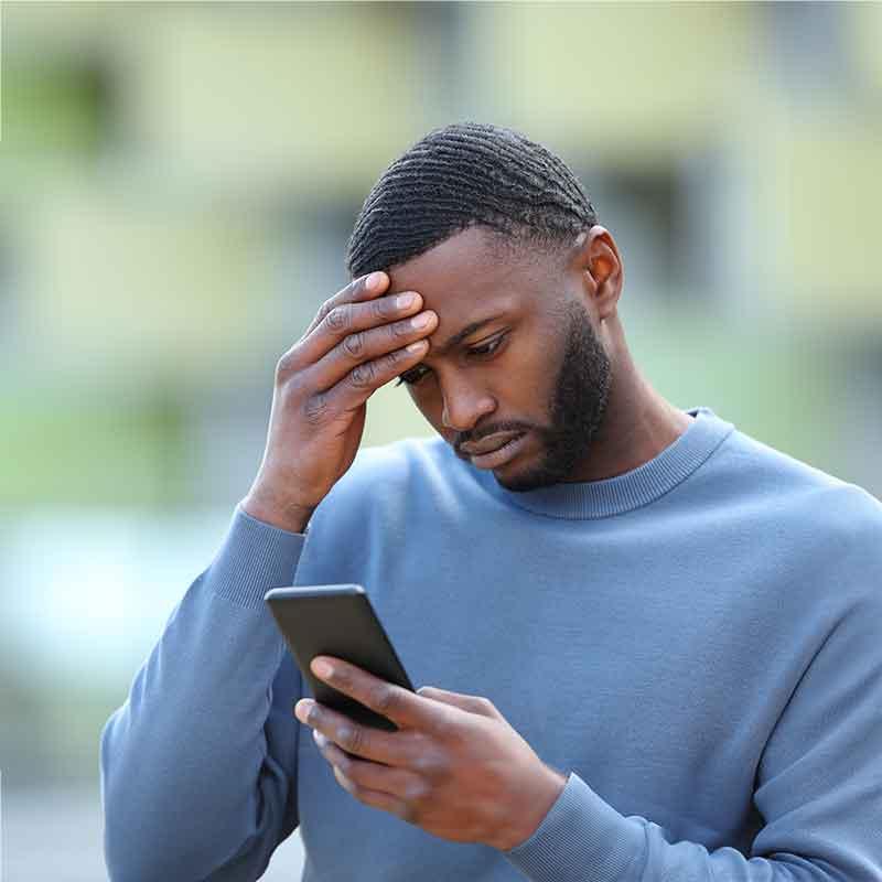 Confused Man looking at mobile device